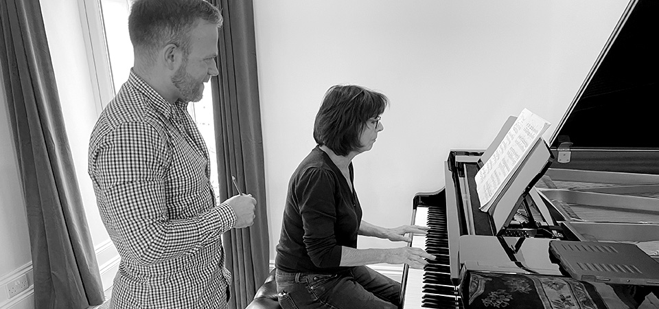 Piano courses - an image of David Quigley with a student at a piano
